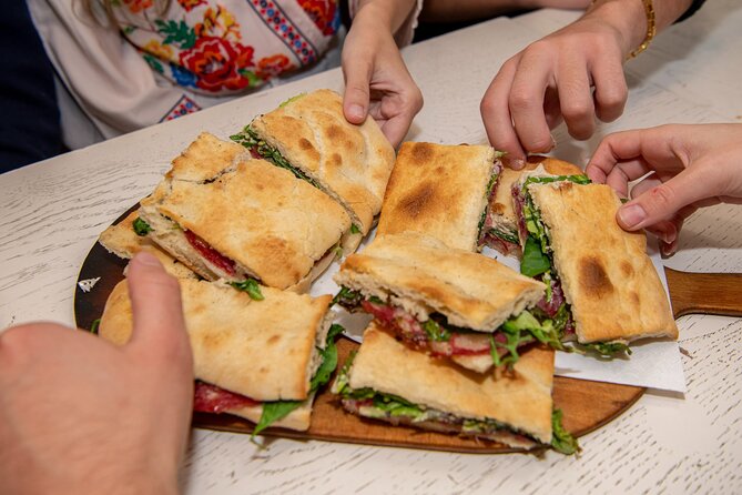 Taste the Flavours of Florence: Private Tuscan Food Tour - A sandwich and a neighborhood welcome